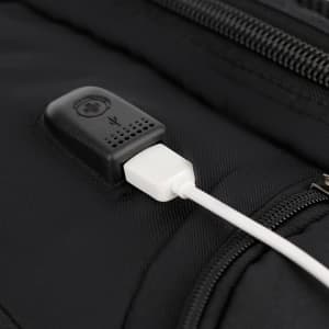 A black backpack featuring a USB charging port, made from durable fabric with a sleek design.