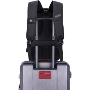 A black Swissdigital Pixel Backpack is attached to a silver trolley suitcase, featuring adjustable straps and a logo.