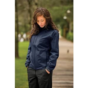 A navy rain jacket with a hood, featuring a logo, worn by a woman outdoors.
