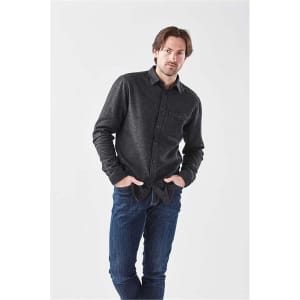 A men's long sleeve twill shirt in dark grey with a button-up front and a chest pocket, worn with blue jeans.