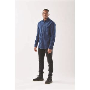 Men's long sleeve twill shirt in navy blue, featuring a button-up design and a chest pocket. The model is wearing black pants and boots.