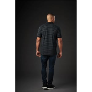 A back view of a man wearing a dark striped polo shirt paired with dark jeans. The shirt features a logo.