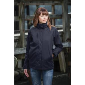 A woman wearing a black women's parka jacket, standing outdoors near a wooden structure.
