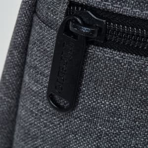 A drink bottle cooler in grey fabric, featuring a zippered compartment and a pull tab with branding.