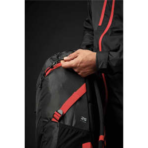 A green and black backpack with red accents, featuring a zippered pocket and a person adjusting the zipper.