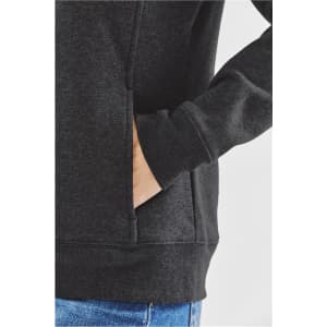 A close-up of a women's black fleece hoodie, highlighting the pocket and fabric texture.