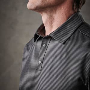 A men's polo shirt in grey with subtle stripes and a branded logo on the collar.