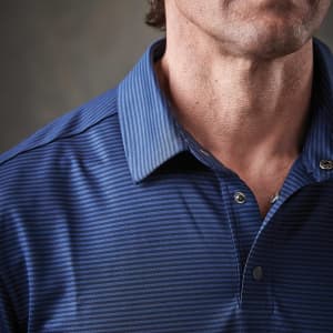 A close-up of a men's blue striped polo shirt featuring a collar and button details. The shirt has a logo on it.