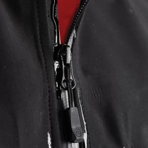 A black softshell jacket featuring a front zipper with a red interior and a logo near the zip area.