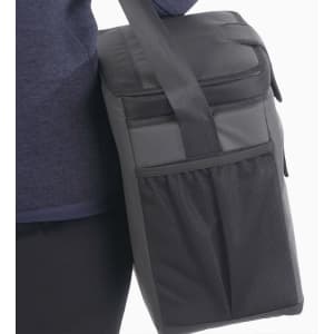 A cooler bag in black, featuring a shoulder strap and a mesh pocket on the side, with branding.
