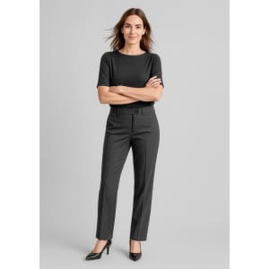A woman stands confidently in black women's comfort wool stretch relaxed pants and a matching top, with a logo visible.