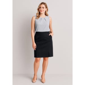 A model wearing a grey top and a black straight skirt with front pleat details, featuring pockets.