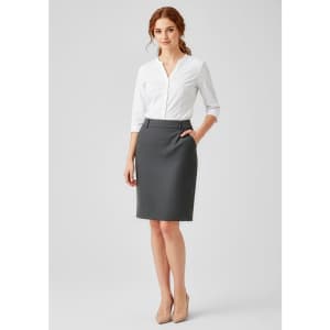 A grey women's comfort wool stretch skirt with pleats, paired with a white blouse. The model has red hair and is wearing nude heels.