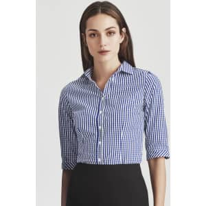 A women's button-up shirt in blue and white gingham check with three-quarter sleeves and a collar, featuring a logo.