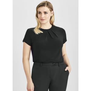A short sleeve black top with a pleated design, worn by a model styled with tailored trousers.