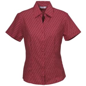A short sleeve button-up shirt in a red and patterned fabric, featuring a collar and a logo.