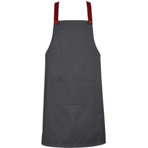 A dark grey apron with red straps and a front pocket, featuring a logo on one side.