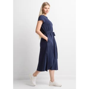 A navy women's midi dress with short sleeves, a belt, and side pockets, paired with white sneakers.