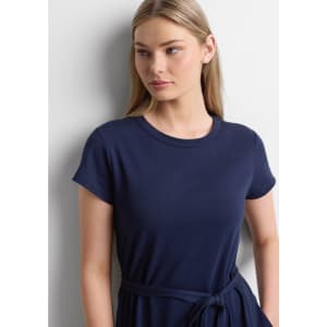 A navy midi dress with short sleeves and a waist tie, modelled by a woman with long hair.