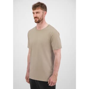A short sleeve tee in a beige colour, featuring a logo, displayed on a male model against a neutral background.