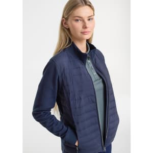 A women's tailor jacket in navy, featuring a zip front and a blend of quilted and smooth fabric.