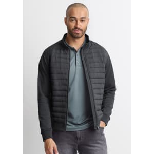 A men's tailored jacket in black, featuring a zip front and quilted detailing, worn over a green polo shirt.