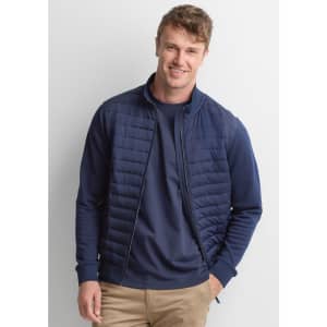 A men's tailor jacket in navy blue, featuring a quilted design and zip-up front, displayed on a smiling model.