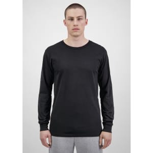 A black long sleeve t-shirt displayed on a model with grey sweatpants. The shirt features a logo.