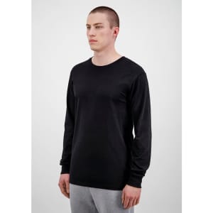 A black long sleeve men's t-shirt displayed on a model, featuring a simple design and fitted style.