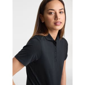 A women's short sleeve polo in black with a collared neckline and buttons, featuring a logo on the chest.