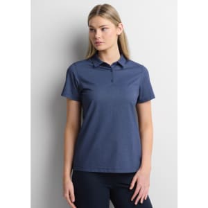 A women's short sleeve polo in navy, featuring a collar and a logo. The model is posing against a neutral background.
