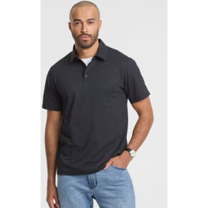 A black short sleeve polo shirt worn by a man, featuring a collar and a subtle logo.
