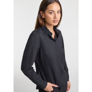 A women's long sleeve shirt in black, featuring a button-down front and a tailored fit, with a branding logo.