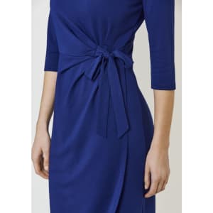 A blue dress featuring a tied detail at the waist and three-quarter sleeves. The dress has a smooth, elegant look.