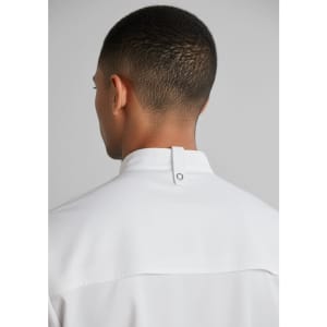 A white short sleeve chef jacket with a stand collar and a back neck tab, showcasing the garment's design.