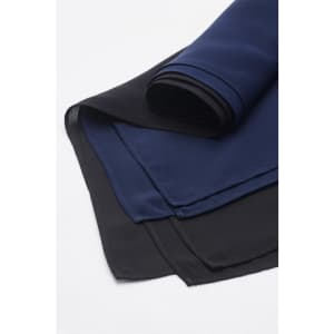 A folded women's hijab featuring layers in navy blue and black, showcasing a smooth fabric texture.