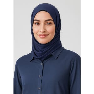 A navy blue hijab worn by a woman, complemented by a button-up shirt. The image features a logo.