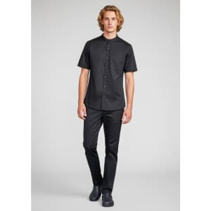 A short-sleeve black chef shirt worn by a model, featuring a button-up design and a chest pocket.