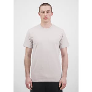A light grey short sleeve tee featuring a crew neck and casual fit, modelled by a person. The tee has a logo.