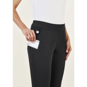 A pair of black women's 3/4 length stretch pants with a pocket, shown being held by a model.