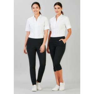 Two women are wearing women's 3/4 length stretch pants in black, paired with white shirts. The pants feature pockets.