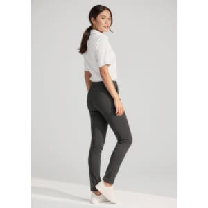 A pair of women's stretch pants in black, worn with a white shirt and white sneakers, featuring a logo.