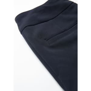 A navy stretch pant featuring a smooth fabric and a pocket detail, with a subtle branding logo.