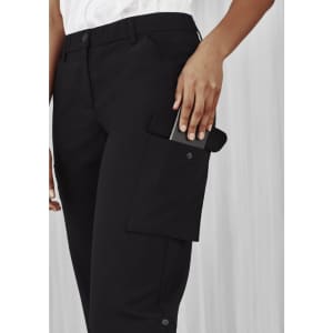 A pair of black women's cargo pants featuring side pockets and a logo, with a hand reaching for a phone.