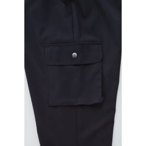 A close-up of black women's cargo pants featuring a side pocket with a button closure and a smooth fabric finish.
