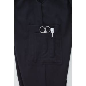A pair of black cargo pants featuring a front pocket with scissors and a pen.