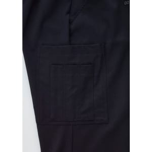 A close-up of black cargo pants featuring a large side pocket and a subtle logo on the waistband.