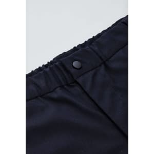 A close-up of black men's comfort waist cargo shorts featuring a button closure and elastic waistband.