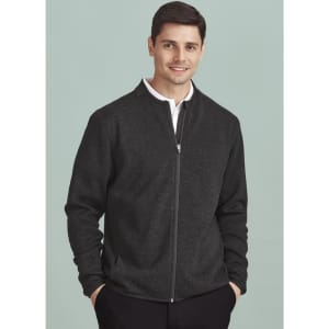 A dark grey zip-front jumper featuring a collar, worn by a smiling man against a light green background.