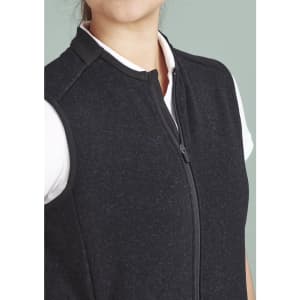 A black zip front vest featuring a high collar and a fitted design, with a white shirt underneath.